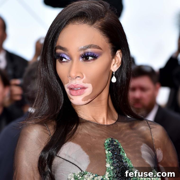 Cannes 2019 Jewellery Dazzles 4 Winnie Harlow wearing Boucheron's Serpent Bohème diamond earrings with a colourful sequin crocodile dress at Cannes Film Festival 2019