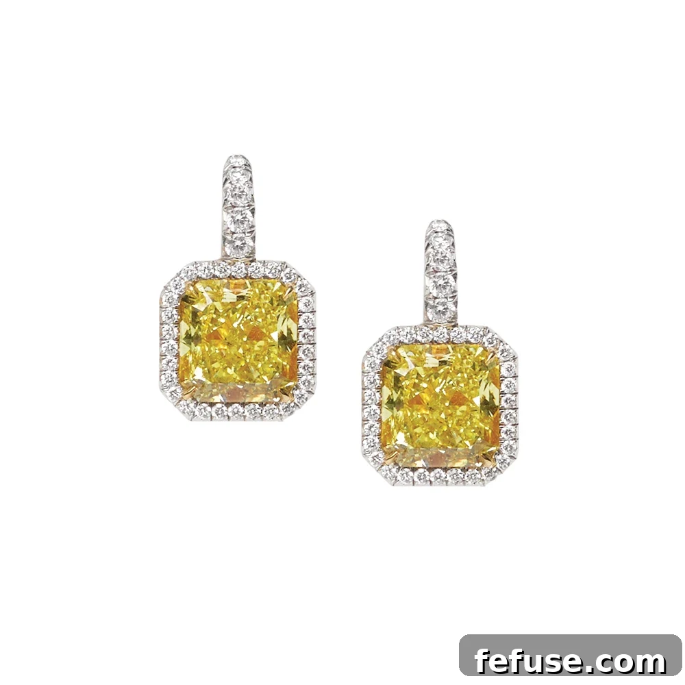 Fancy Intense Yellow Diamond and Diamond Earrings - Handmade Stephen Silver Fancy Intense Yellow VS Radiant Cut diamond earrings, surrounded by diamonds in platinum.