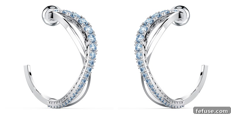 Celebrate Brilliance The New Swarovski 125th Anniversary Collection 3 Close-up of a Swarovski Twist Collection ring showcasing the intricate spiral design and crystal setting with blue and white stones.