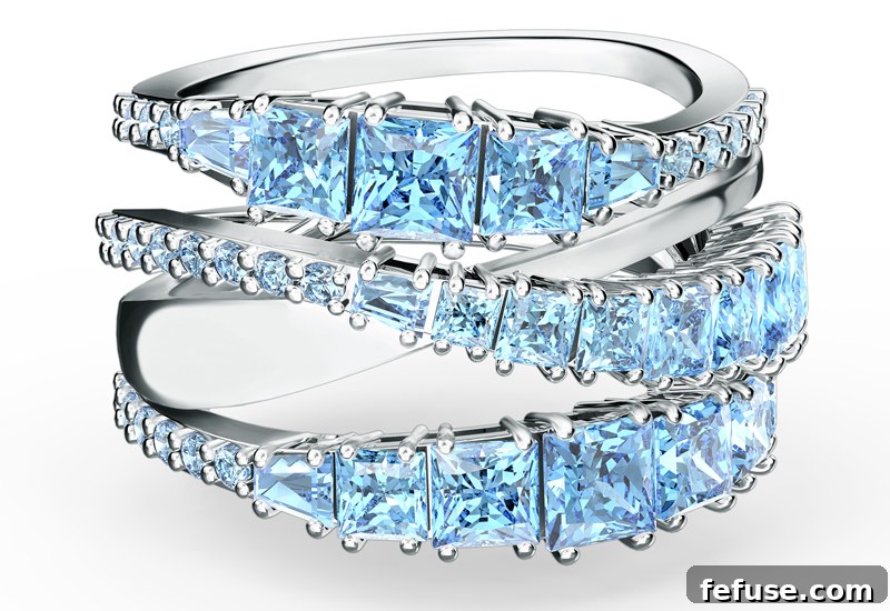 Celebrate Brilliance The New Swarovski 125th Anniversary Collection 5 Detailed view of the Swarovski Twist Collection hoop earrings with sparkling blue and white crystals, capturing their intricate craftsmanship.