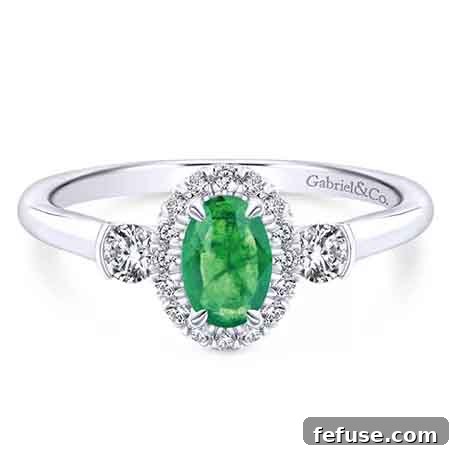 Classic emerald solitaire engagement ring with diamond accents in 14k white gold