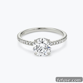 The Art of the Stack: Pairing Engagement Ring Shapes with the Perfect Wedding Band 2 The Signature Solitaire Ring in Platinum (Featuring a Round Brilliant Stone and Pavé Band)