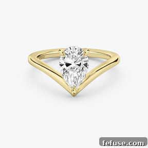The Art of the Stack: Pairing Engagement Ring Shapes with the Perfect Wedding Band 7 The Vintage Inspired Signature V Solitaire Ring in 18k Yellow Gold (Featuring a Pear Cut Stone and Plain Band)