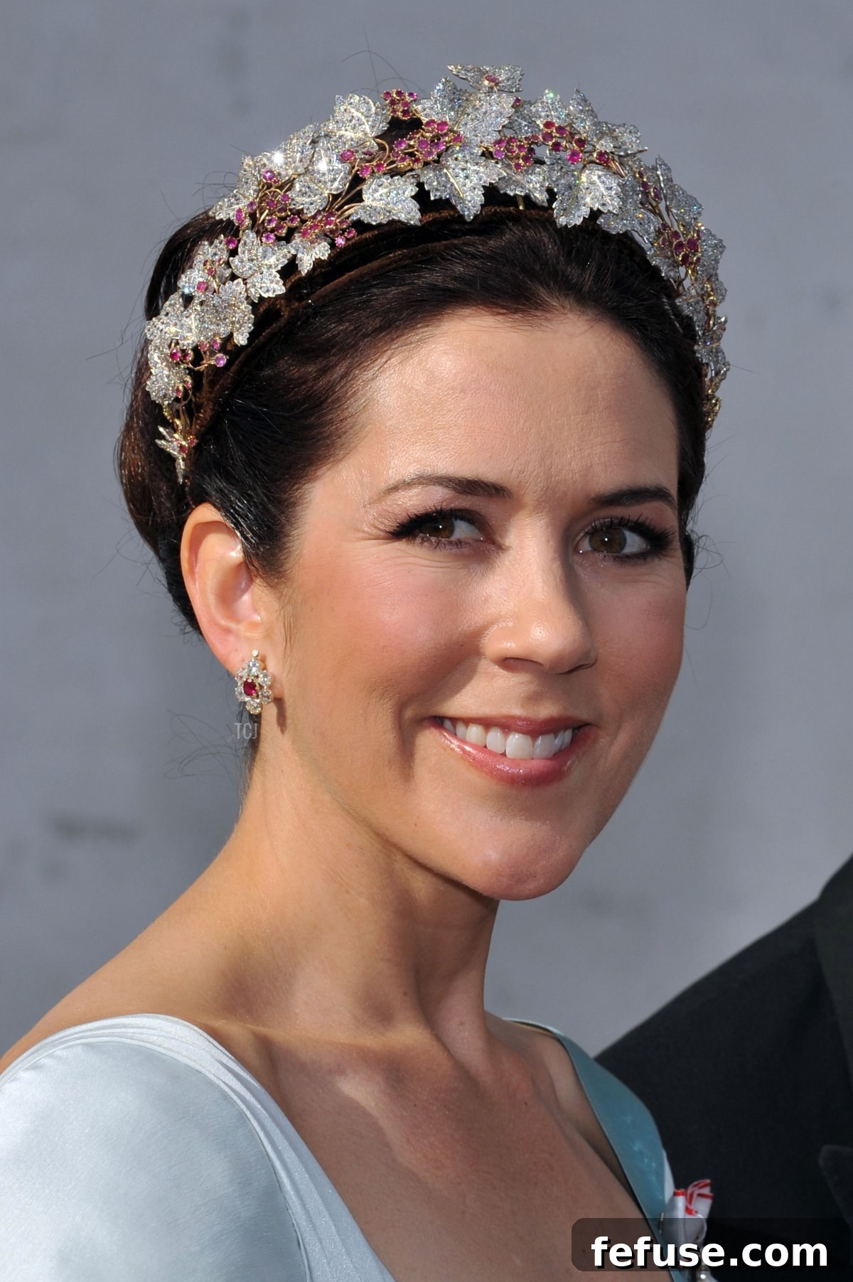 Crown Princess Mary departing from Prince Joachim's wedding, her Danish Ruby Parure shining, embodying national colors