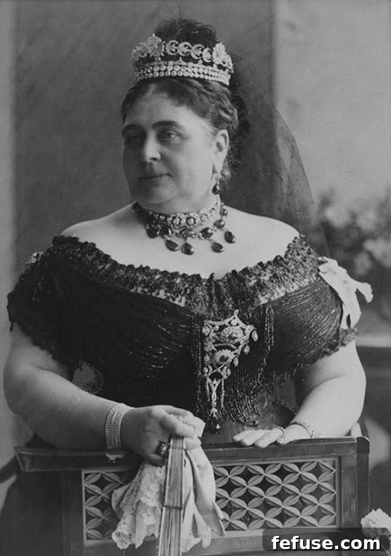 Princess Mary Adelaide, Duchess of Teck, photographed around 1893, wearing the Cambridge Emerald necklace, earrings, and an embellished stomacher.
