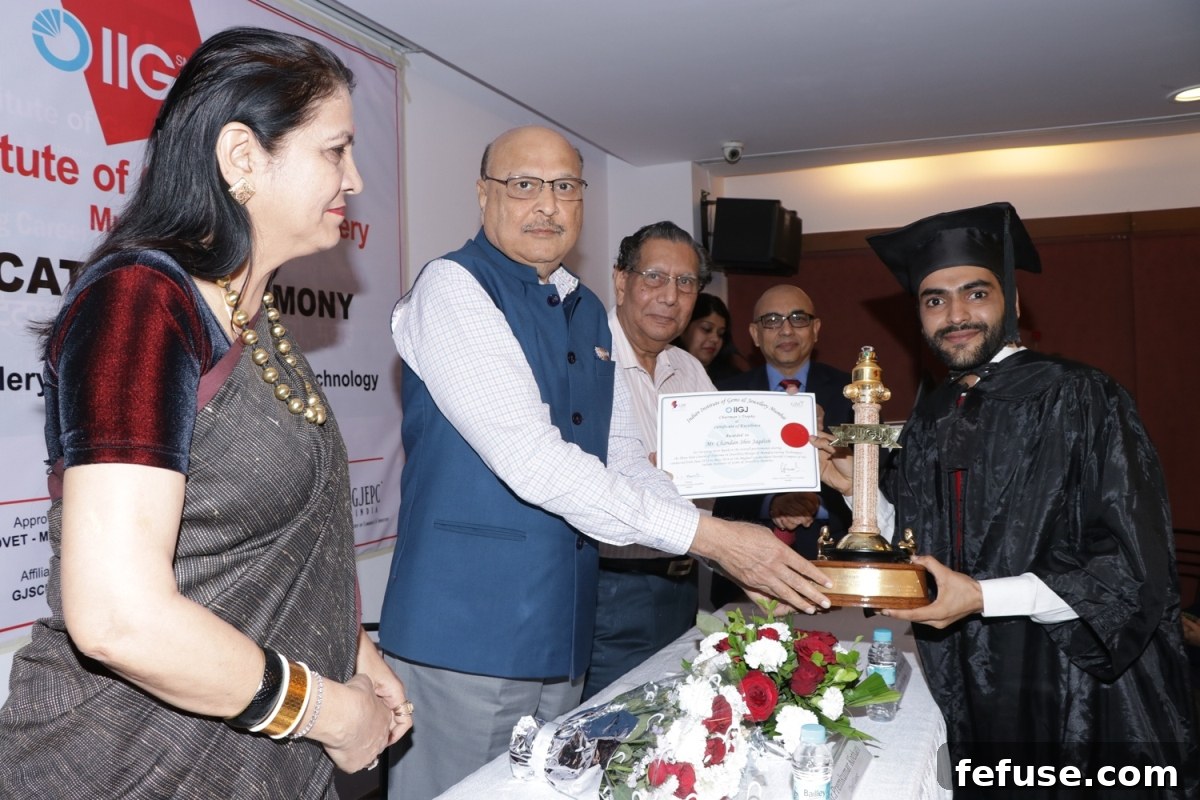 Ms. Namita Pandya, Mr. Premkumar Kothari, Mr. Nirmalkumar Barmecha, and Mr. Sanjoy Ghosh felicitating a top-ranked student at IIGJ's Diploma Course Convocation in Jewellery Design & Manufacture Technology
