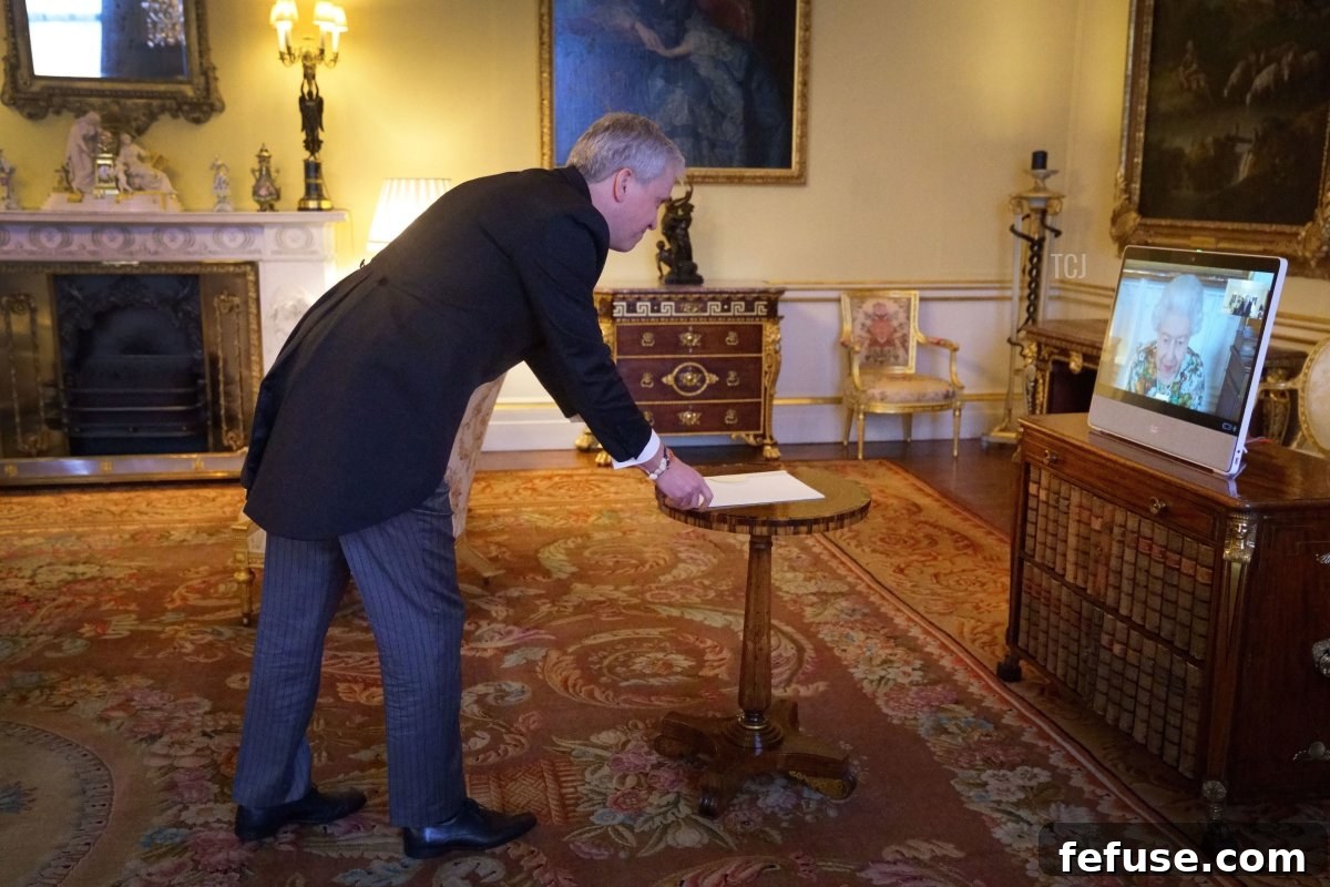 Queen Elizabeth II appears on a screen via videolink from Windsor Castle, where she is in residence, during a virtual audience to receive the Ambassador of Estonia, Viljar Lubi, at Buckingham Palace on February 15, 2022 in Windsor, England