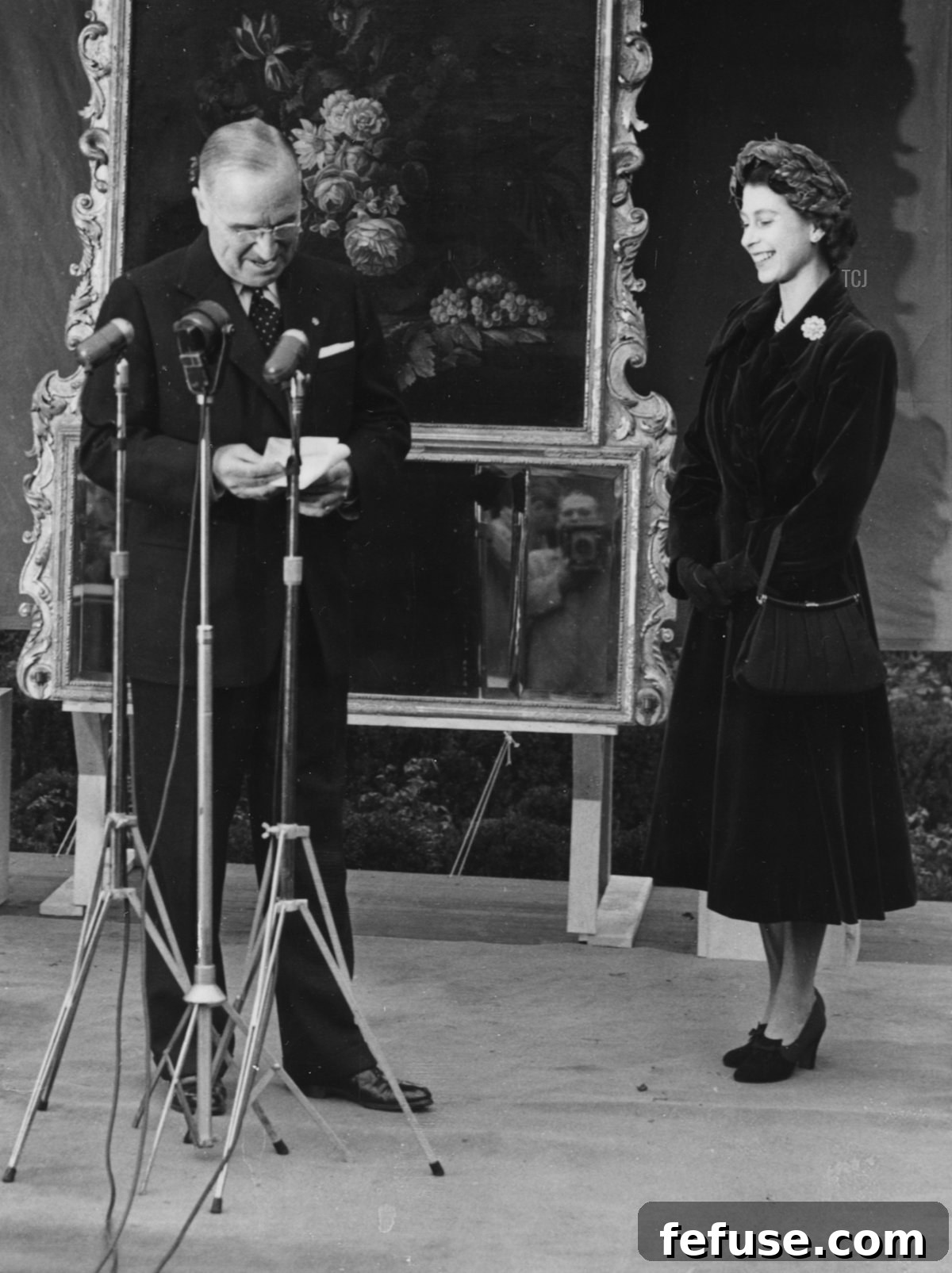 Princess Elizabeth and Prince Philip, the Duke of Edinburgh, smiling as President Harry Truman gives a speech and his aide, General Harry Vaughan (extreme left) looks on, in Washington DC, November 5th 1951