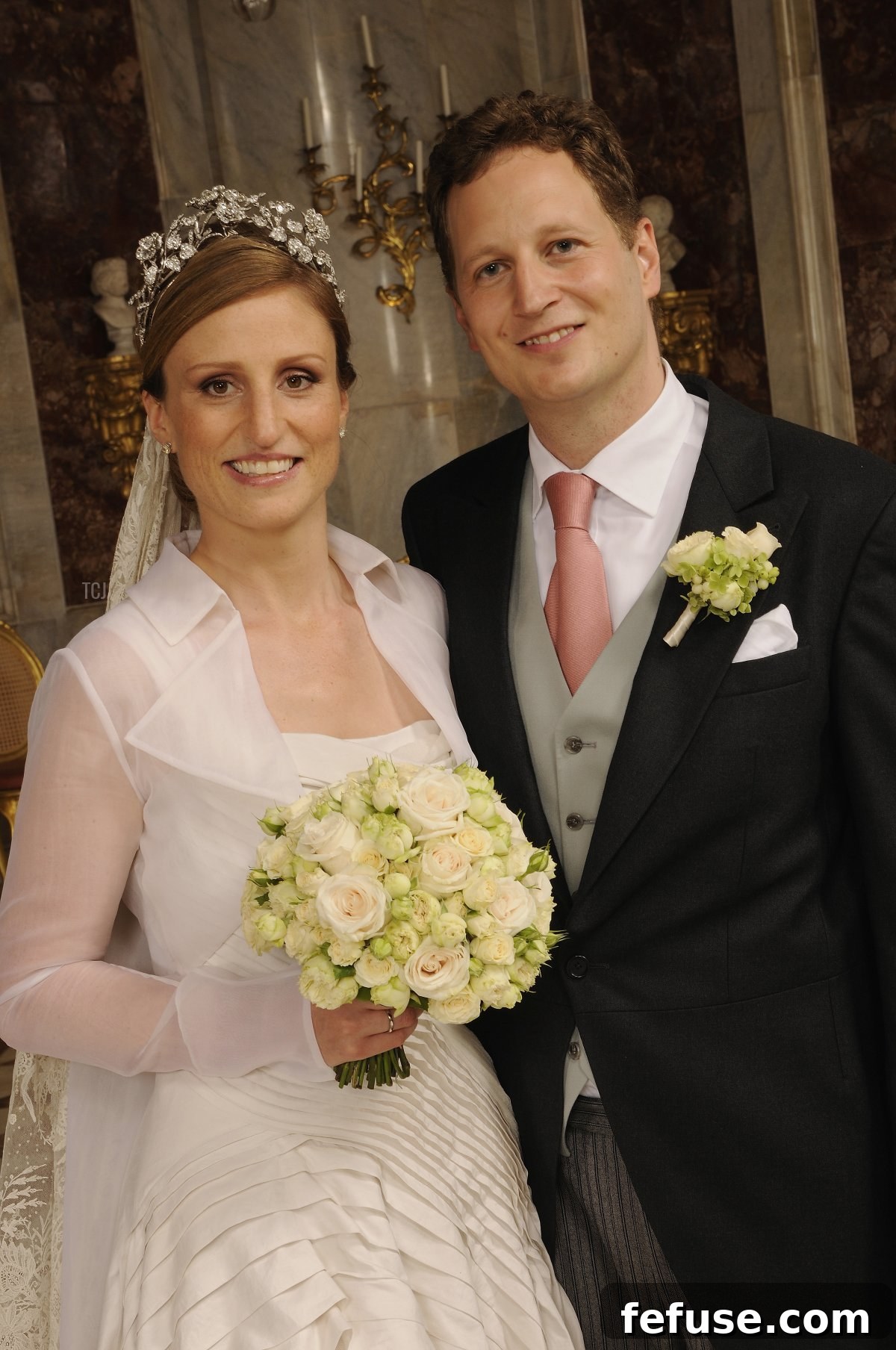 Princess Sophie of Prussia's wedding gown by Wolfgang Joop, featuring a modern pleated dress and a sheer jacket during her wedding ceremony.