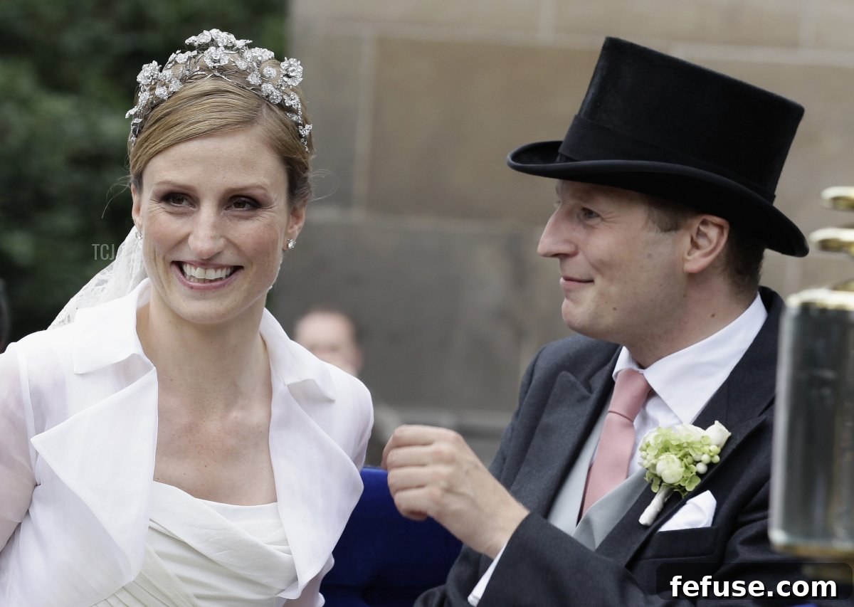 Prince Georg Friedrich of Prussia and Princess Sophie of Prussia smiling during their ride in a historical carriage after their religious wedding ceremony in Potsdam.