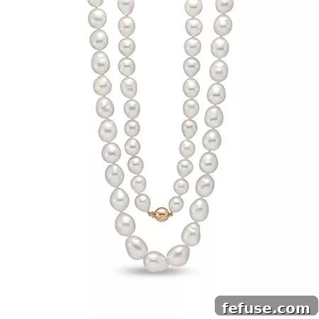 Luxurious opera strand of white baroque South Sea pearls with 18k yellow gold clasp by Mastoloni