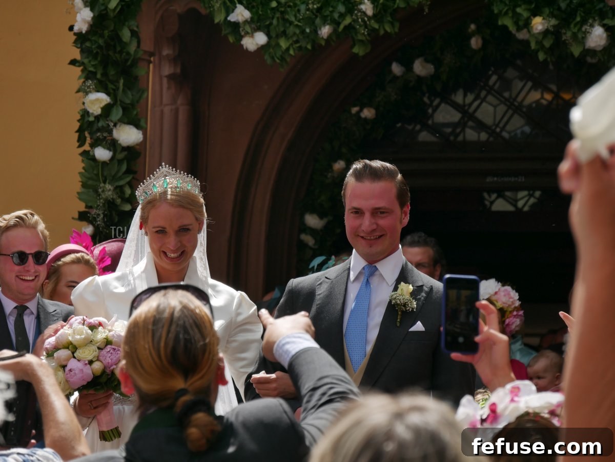 Germany's Princely Emerald Bridal Crown 2 Princess Amelie zu Löwenstein-Wertheim-Freudenberg arriving for her wedding in Wertheim, May 2022, showcasing her bridal gown and a magnificent tiara.