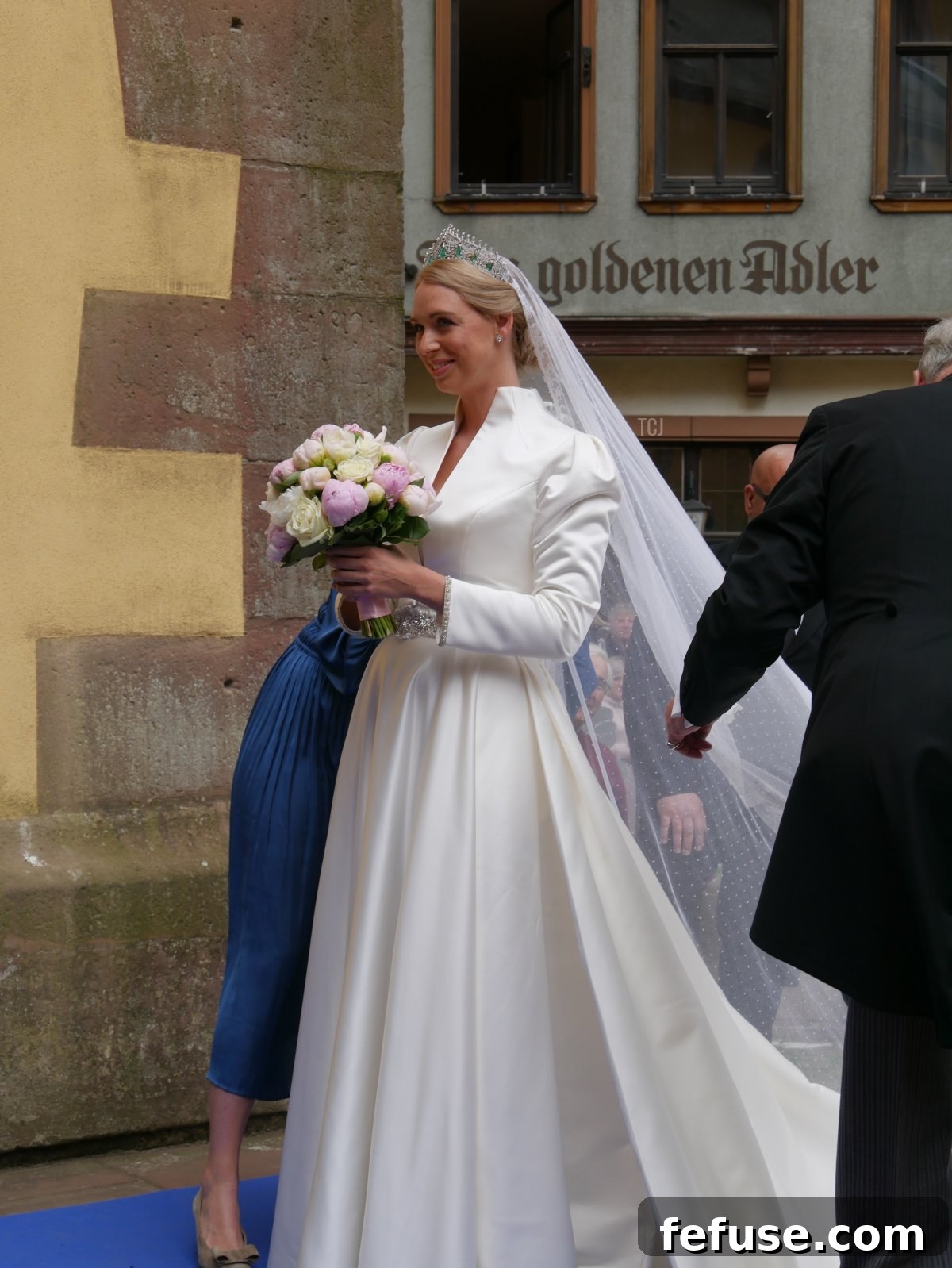 Germany's Princely Emerald Bridal Crown 4 A stunning full-length view of Princess Amelie's wedding gown, featuring a stylish jacket with sparkling embellishments and a delicate crystal belt.