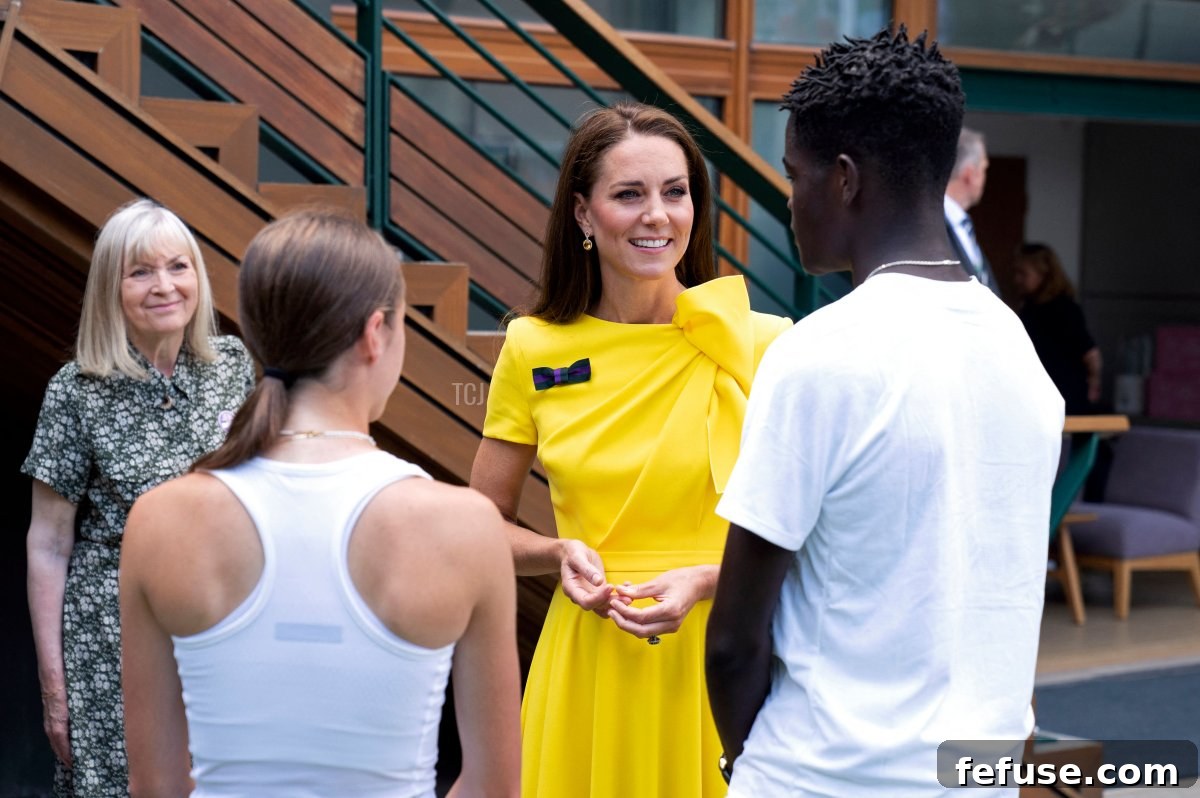 In this handout picture released by the AELTC, Britain's Catherine, Duchess of Cambridge (C), Patron of the All England Lawn Tennis Club, meets two semi-finalists in the inaugural 14&U Junior Championships: Britain's Isabelle Britton (L) and US player Carel Ngounoue (R), on the thirteenth day of the 2022 Wimbledon Championships at The All England Tennis Club in Wimbledon, southwest London, on July 9, 2022