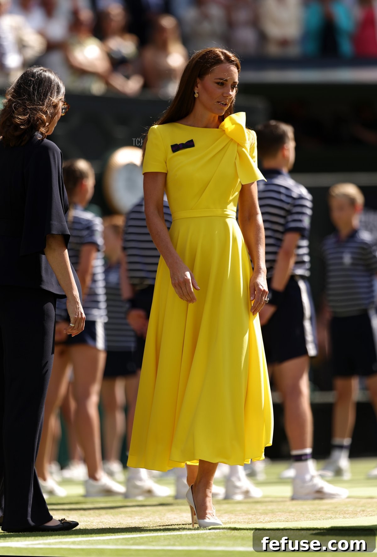 HRH Catherine, The Duchess of Cambridge walks out to present the trophy to Elena Rybakina of Kazakhstan after victory against Ons Jabeur of Tunisia during the Ladies' Singles Final match on day thirteen of The Championships Wimbledon 2022 at All England Lawn Tennis and Croquet Club on July 09, 2022 in London, England