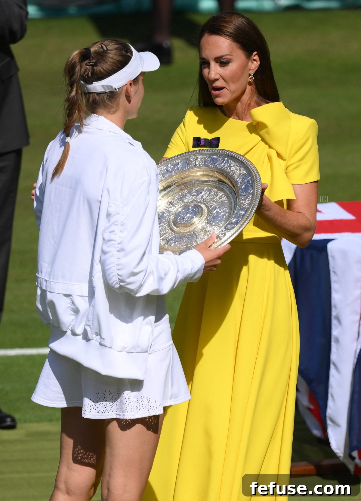 Britain's Catherine, Duchess of Cambridge gives the Venus Rosewater Dish trophy to Kazakhstan's Elena Rybakina during the podium ceremony after winning the women's singles final tennis match against Tunisia's Ons Jabeur on the thirteenth day of the 2022 Wimbledon Championships at The All England Tennis Club in Wimbledon, southwest London, on July 9, 2022