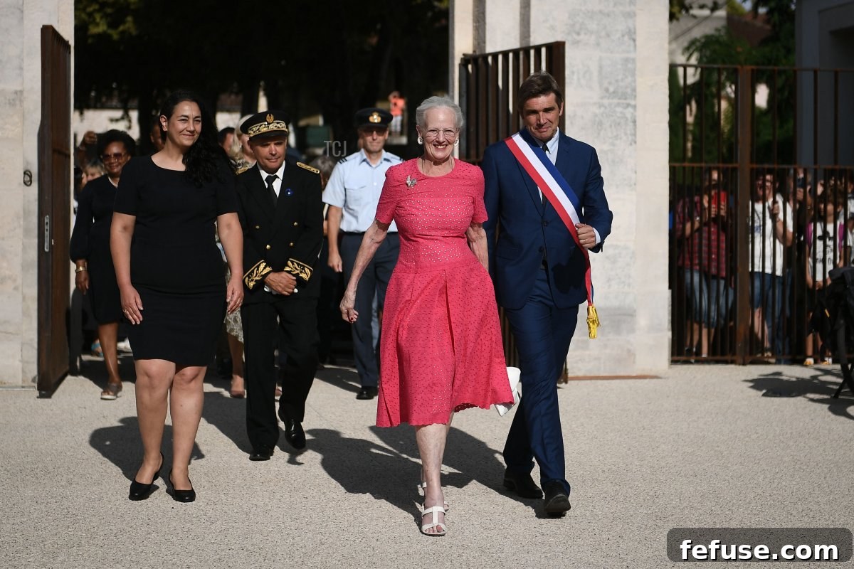 Queen Margrethe II of Denmark (2nd R), flanked by the mayor of Cahors Jean-marc Vayssouze-Faure (R) and director of the Cahors museum Rachel Amalric (L), arrives at the Henri Martin museum for the inauguration of her works, in Cahors, southern France, on August 17, 2022