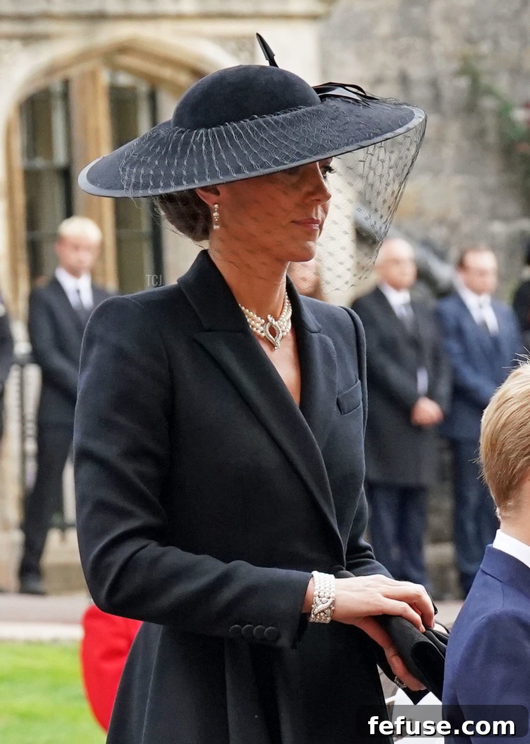 The Princess of Wales and Prince George arrive at the Committal Service for Queen Elizabeth II at St George's Chapel, Windsor, with Catherine wearing a distinctive four-row pearl bracelet.