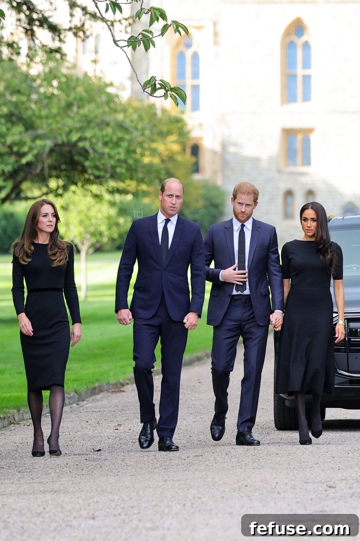 Catherine, Princess of Wales, Prince William, Prince of Wales, Prince Harry, Duke of Sussex, and Meghan, Duchess of Sussex on the long Walk at Windsor Castle, viewing floral tributes following the Queen's passing.