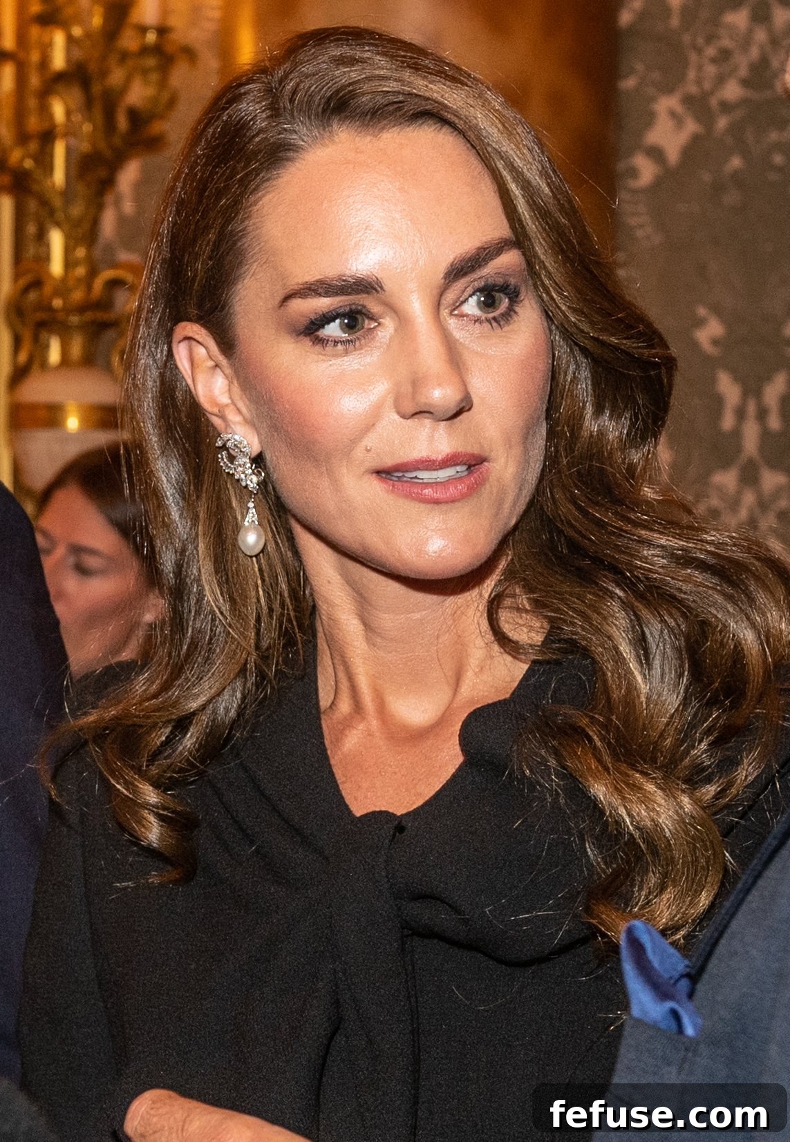 Catherine, Princess of Wales, attends a reception for Heads of State at Buckingham Palace, wearing elegant diamond and pearl drop earrings from Diana's collection.