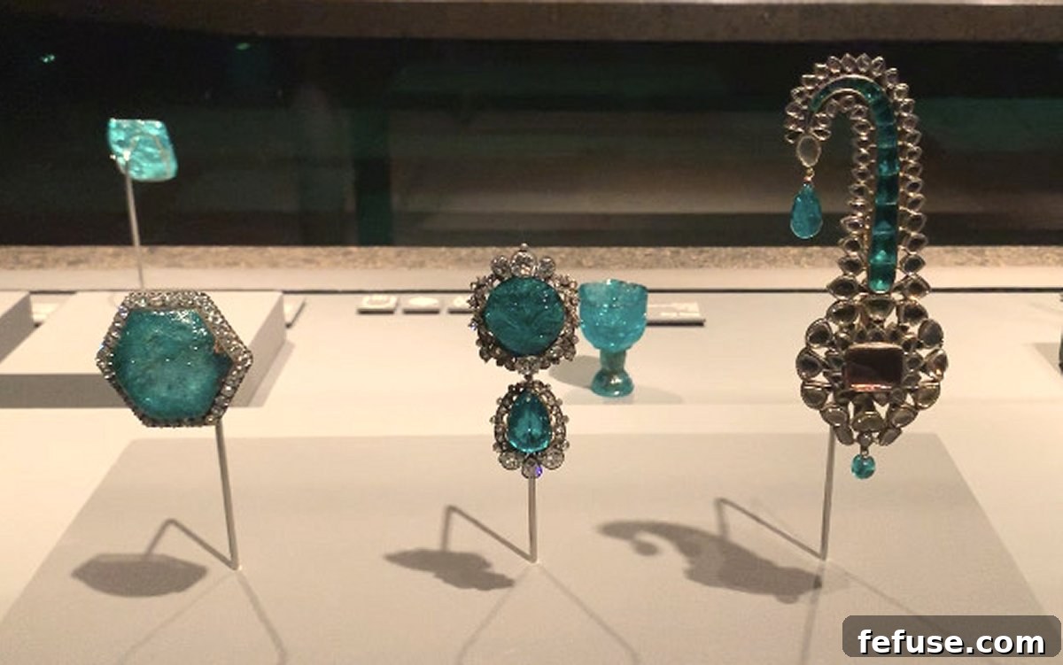 Close-up of Indian royal jewels, including a prominent diamond and emerald sarpech, at the National Museum of Qatar exhibition