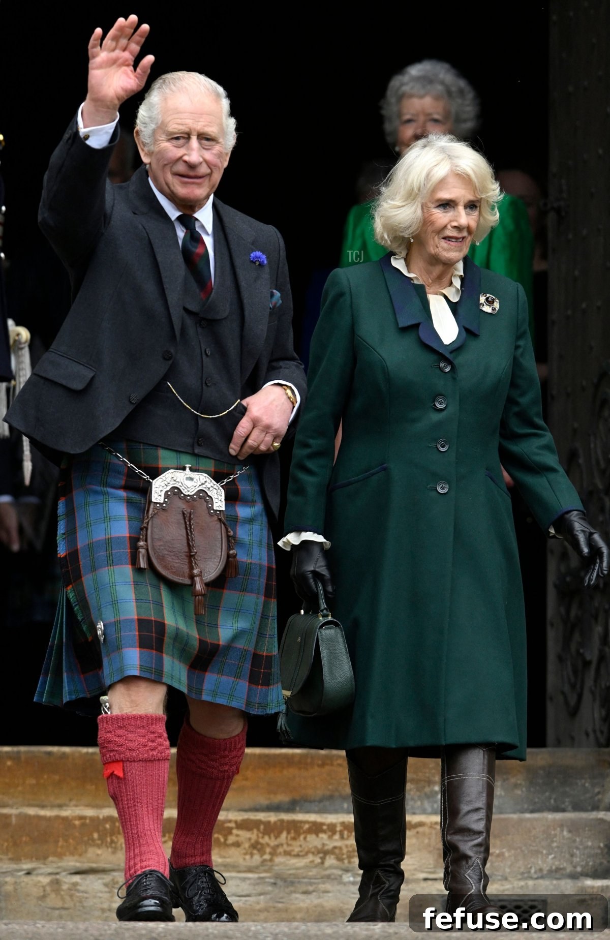 Britain's King Charles III and Britain's Camilla, Queen Consort wave as they walk to meet members of the public after leaving from City Chambers to Dunfermline Abbey in Dunfermline in south east Scotland on October 3, 2022