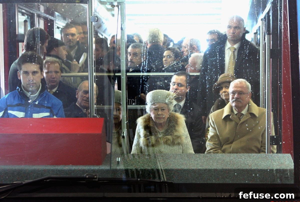 Queen Elizabeth II, Prince Philip, and President Ivan Gasparovic of Slovakia ride a funicular railway to Hrebienok Ski Resort.