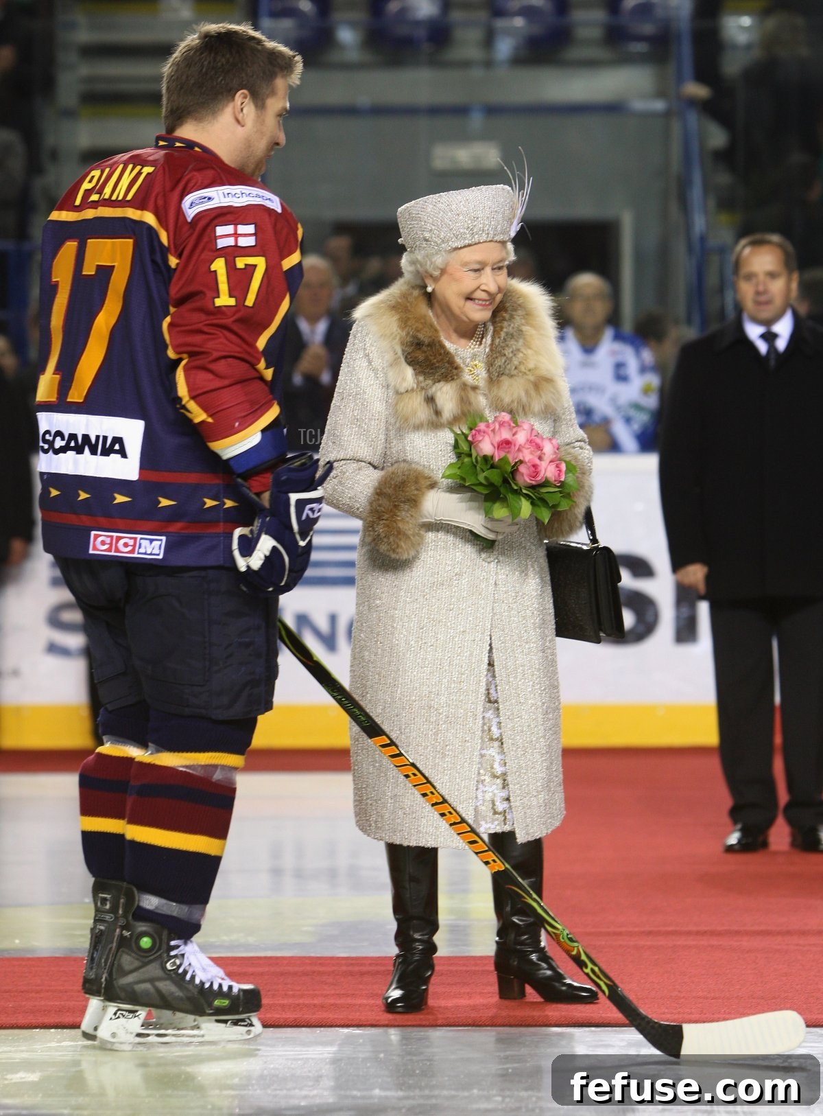 Queen Elizabeth II laughs with an ice hockey player before a match between Aqua City Poprad and Guildford Flames in Bratislava, Slovakia, October 24, 2008.