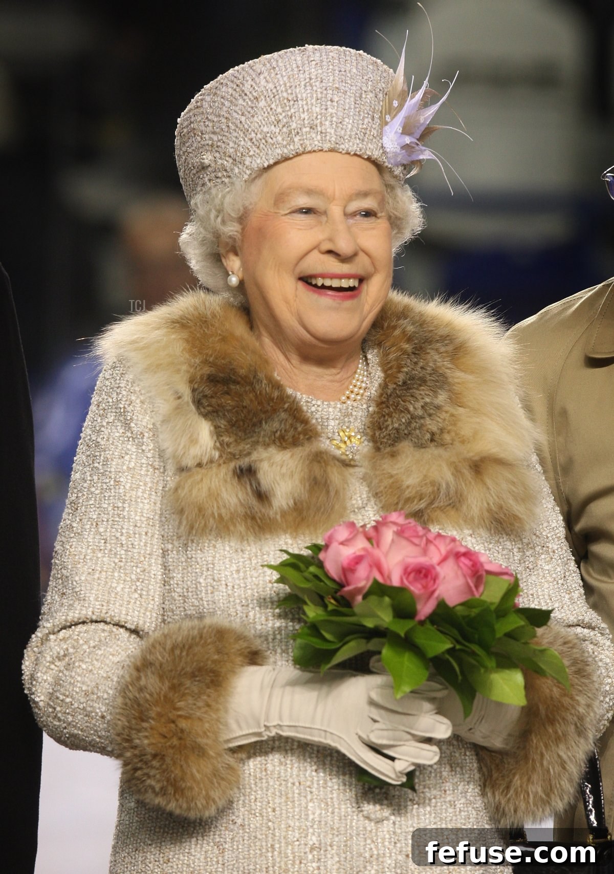 Queen Elizabeth II laughs after dropping the puck to start an ice hockey match in Bratislava, Slovakia.