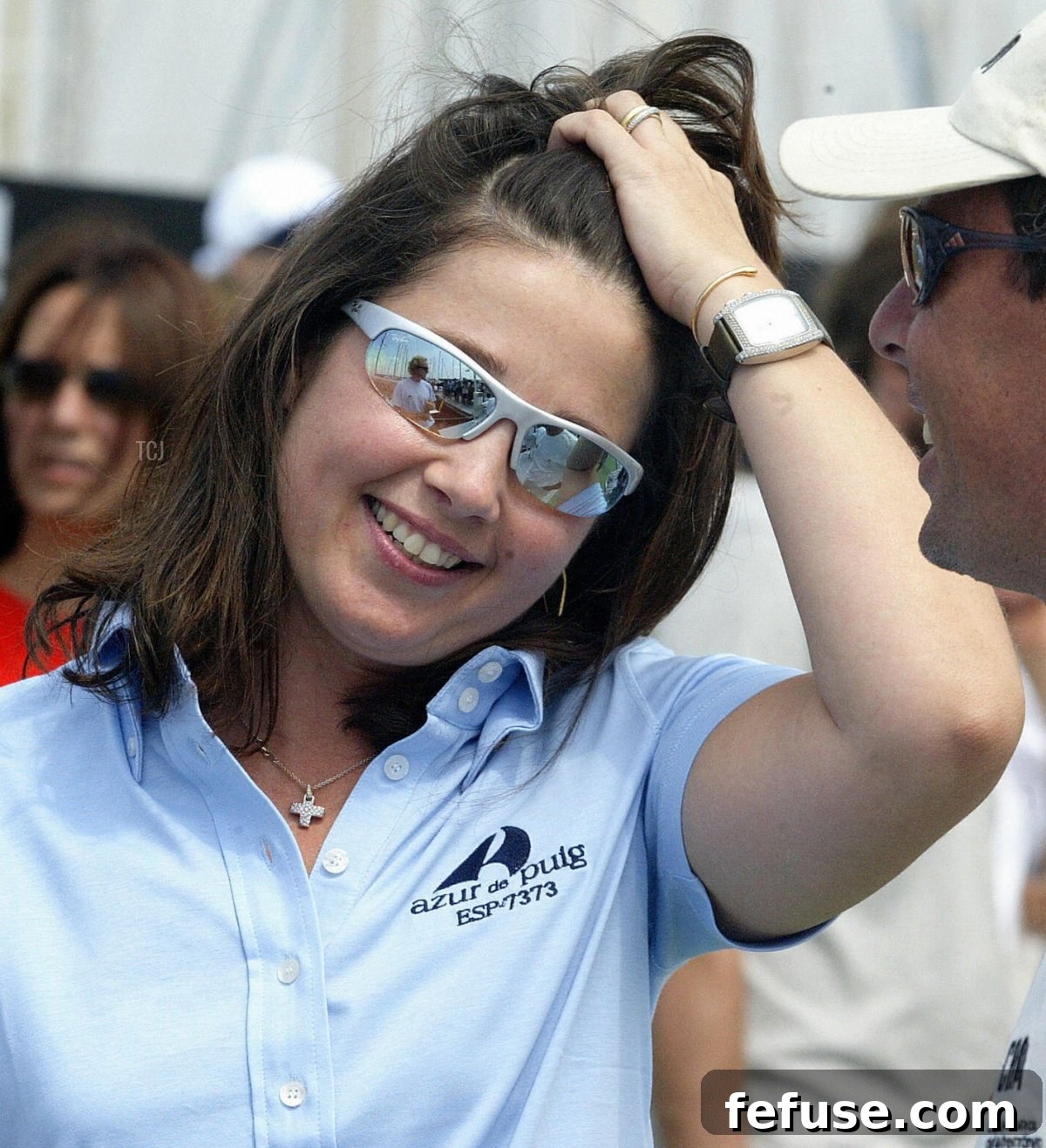 Princess Alexia of Greece and Denmark smiles as she chats with a man prior to the beginning of the Queen's cup boat race on off the coast of Valencia, 02 July 2004 (JOSE JORDAN/AFP via Getty Images)