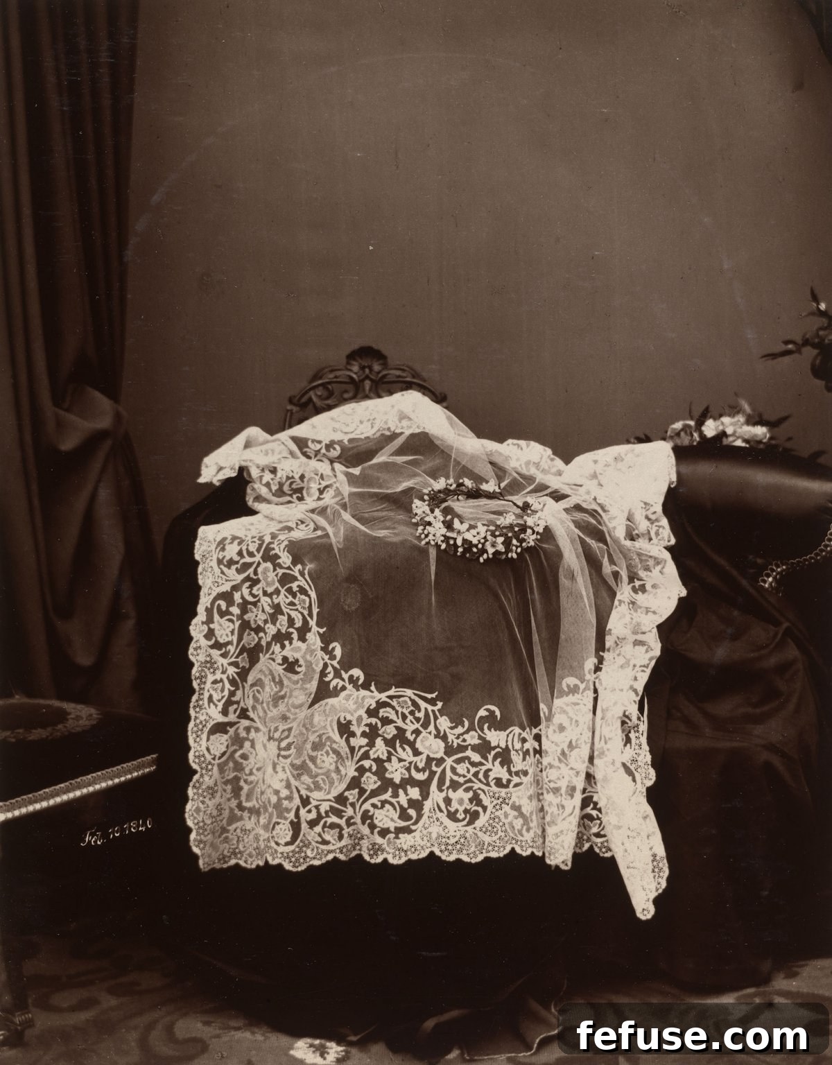 Carbon print of a photograph taken by an unknown person ca. 1889-91, of Queen Victoria's wedding veil made of Honiton lace and wreath decorated with orange blossoms, worn for her marriage on 10 February 1840 (Royal Collection)