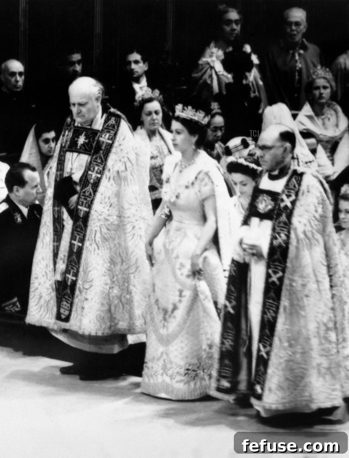 Queen Elizabeth II's solemn entrance into Westminster Abbey for her Coronation ceremony on June 2, 1953, flanked by ecclesiastical figures. (INTERCONTINENTALE/AFP via Getty Images)