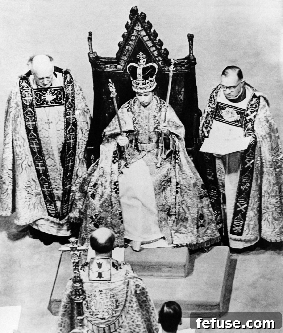Queen Elizabeth II, crowned with St. Edward's Crown and holding the Sceptres, seated on the Coronation Chair during her 1953 Coronation ceremony. (INTERCONTINENTALE/AFP via Getty Images)
