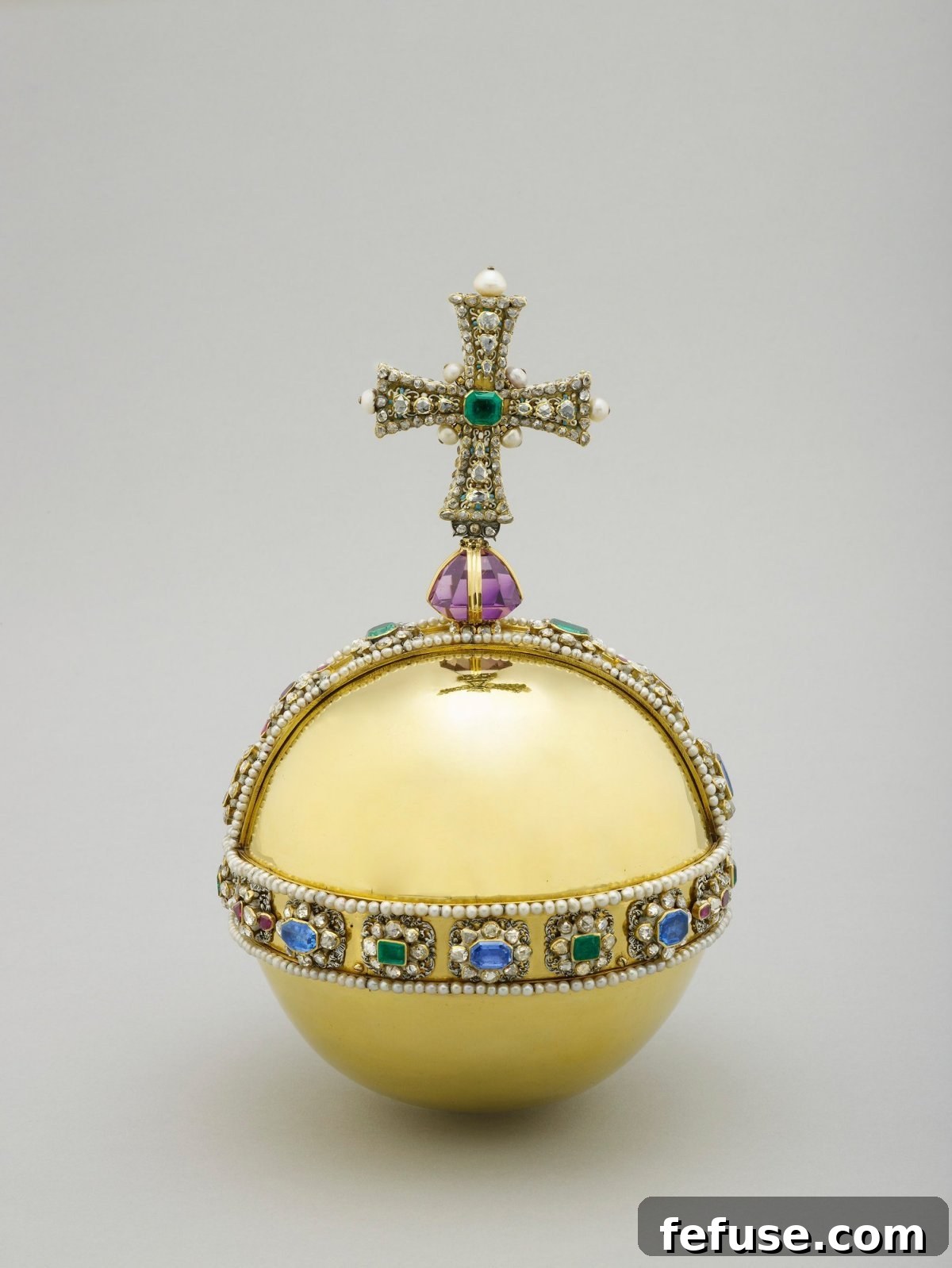 The Sovereign's Orb, a gilded globe topped with a cross, symbolizing the Christian world, part of the British Crown Jewels. (Royal Collection Trust)