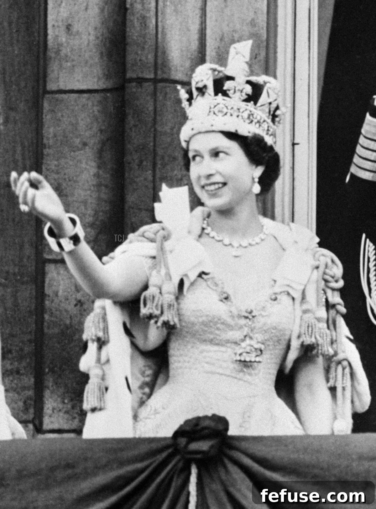 Queen Elizabeth II waving to immense crowds from the balcony of Buckingham Palace on June 2, 1953, after her Coronation at Westminster Abbey. (INTERCONTINENTALE/AFP via Getty Images)