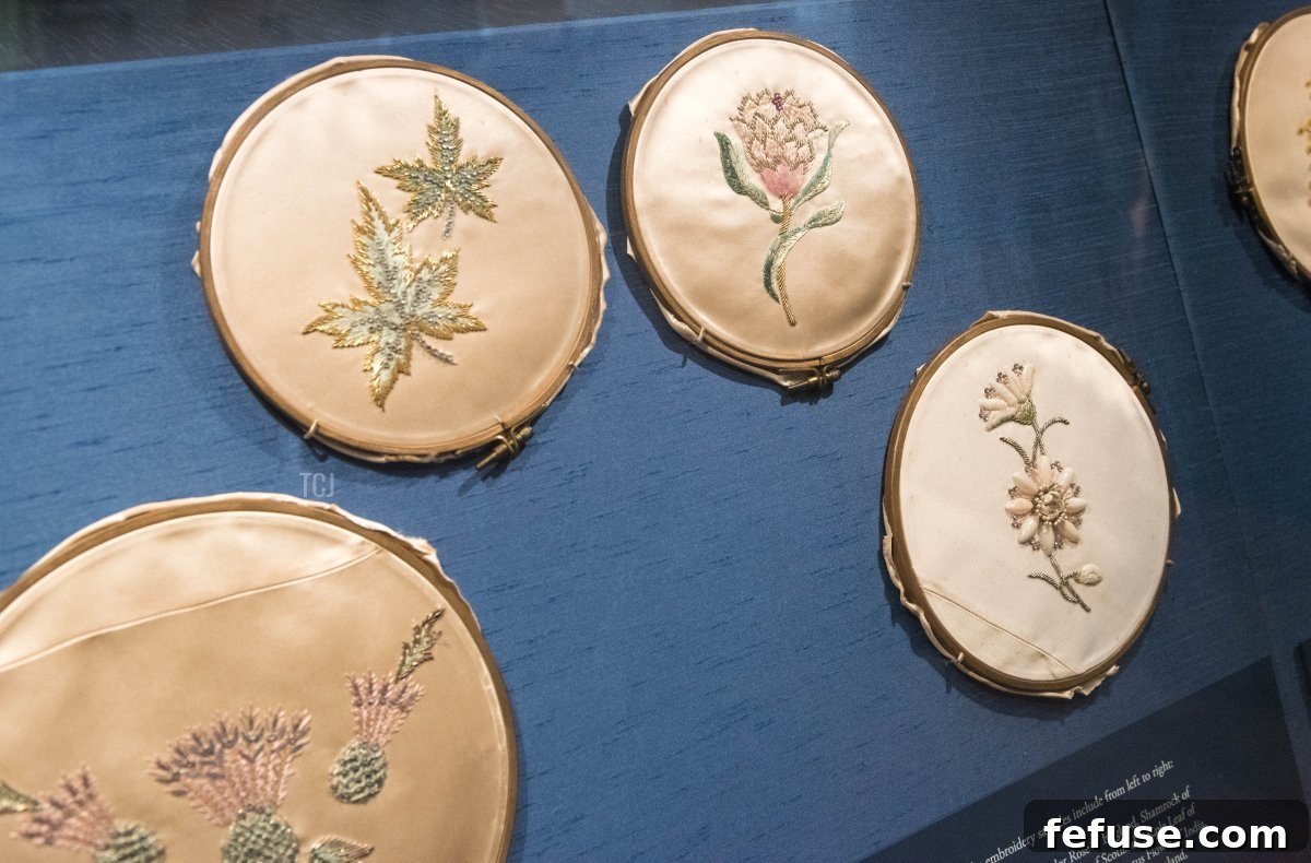 Close-up of original embroidery samples for Queen Elizabeth II's Coronation dress, showcasing the intricate detail and national symbols, exhibited at Windsor Castle. (Nicky J Sims/Getty Images)