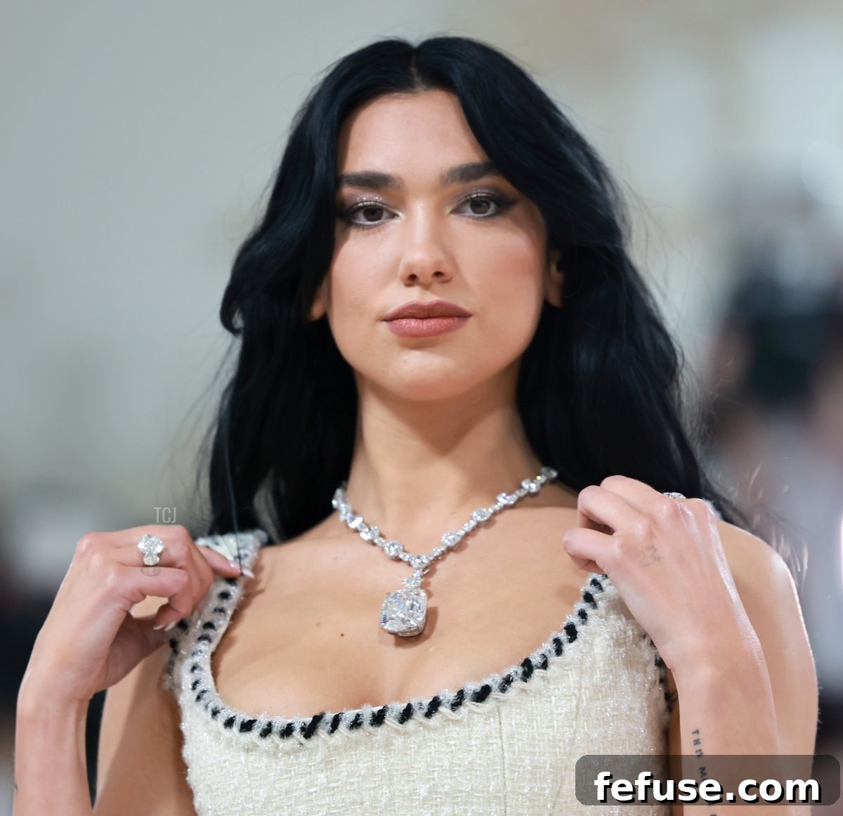 Dua Lipa's subtle yet elegant supporting jewelry, including a Tiffany ring set with diamonds, complementing her magnificent necklace at Met Gala 2023.