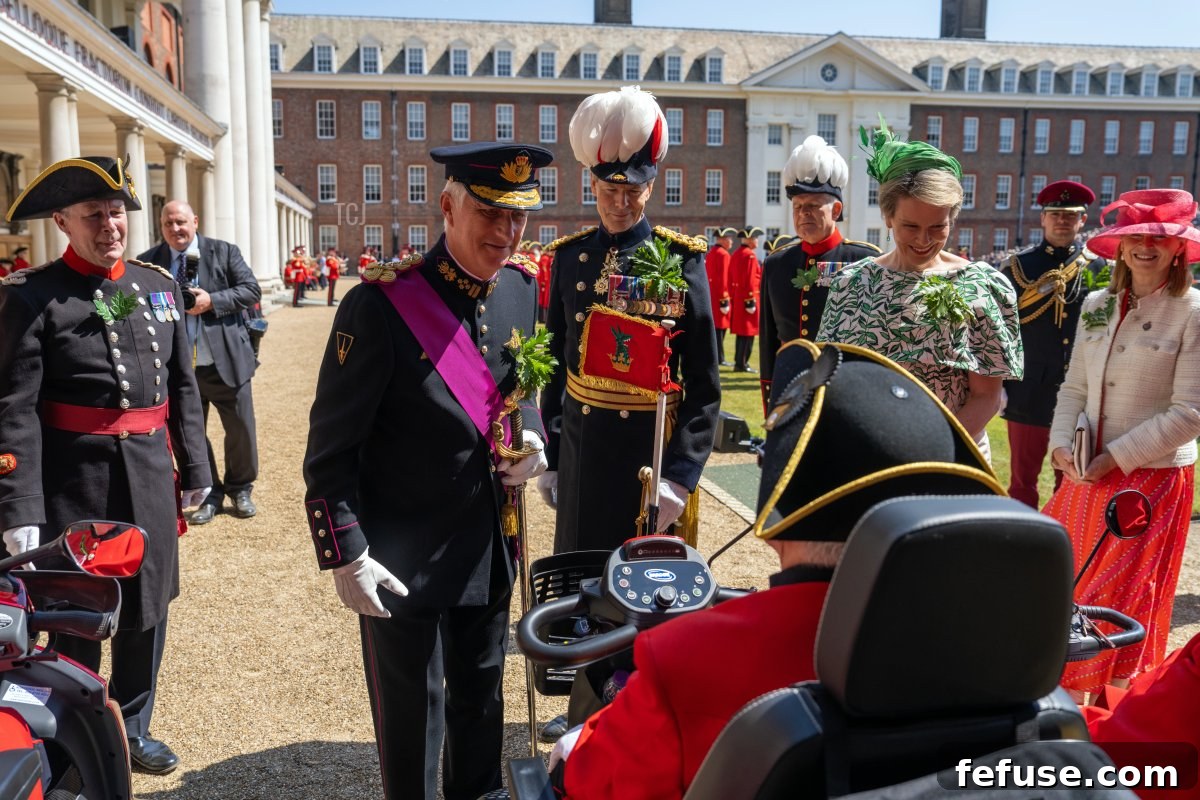 King Philippe and Queen Mathilde engage with Chelsea Pensioners at the Founder's Day Parade. (Carl Court/Getty Images)