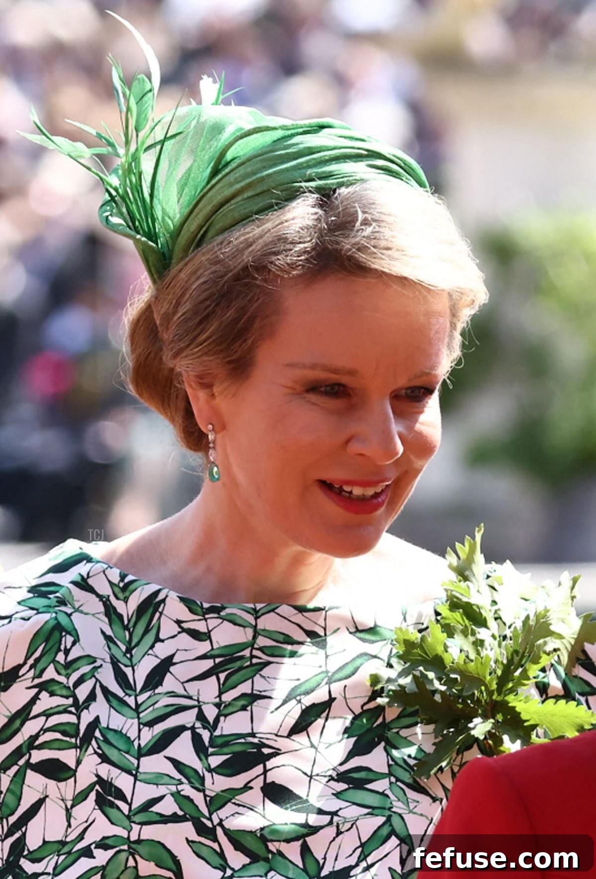 A close-up of Queen Mathilde of the Belgians showcasing her emerald drop earrings at the Founder's Day Parade. (HENRY NICHOLLS/AFP via Getty Images)