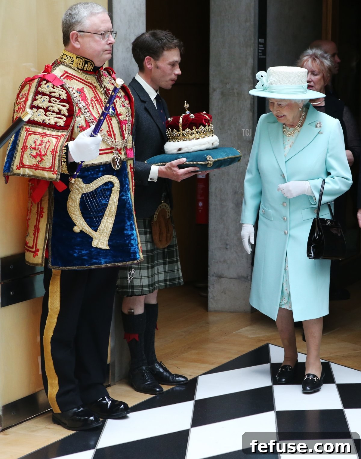 Queen Elizabeth II inspects the Crown of Scotland, held by the Duke of Hamilton, as they walk through the Black and White Corridor following the opening of the fifth session of the Scottish Parliament on July 2, 2016 in Edinburgh, United Kingdom (Andrew Milligan/WPA Pool/Getty Images)