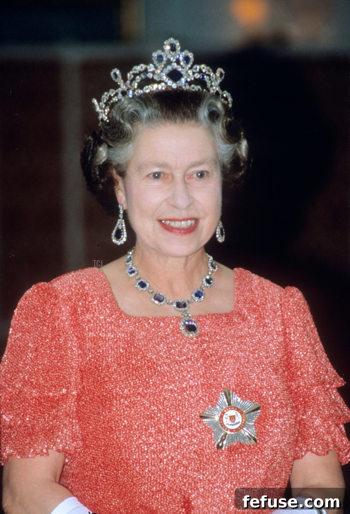 The Enduring Radiance of King George VI's Royal Sapphires 13 Queen Elizabeth II is pictured onboard the royal yacht Britannia during her visit to Singapore, 1989 (David Cooper/Alamy)