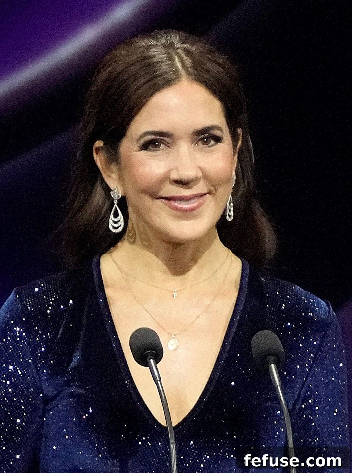 Crown Princess Mary of Denmark, with a focused expression, presents an award in the Concert Hall of Musikhuset Esbjerg on November 4, 2023, displaying her elegant accessories. (Ritzau Scanpix/Alamy)