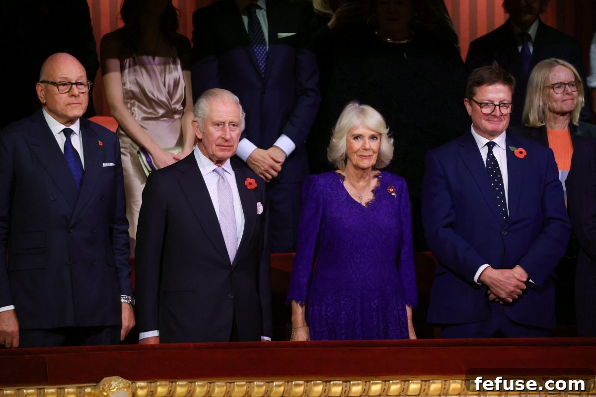 Regal Pink Topaz and Sapphire Pendant for Queen Camilla 4 King Charles III and Queen Camilla seated among the public in a balcony section at the Royal Opera House, highlighting their approachable style and connection with British citizens.