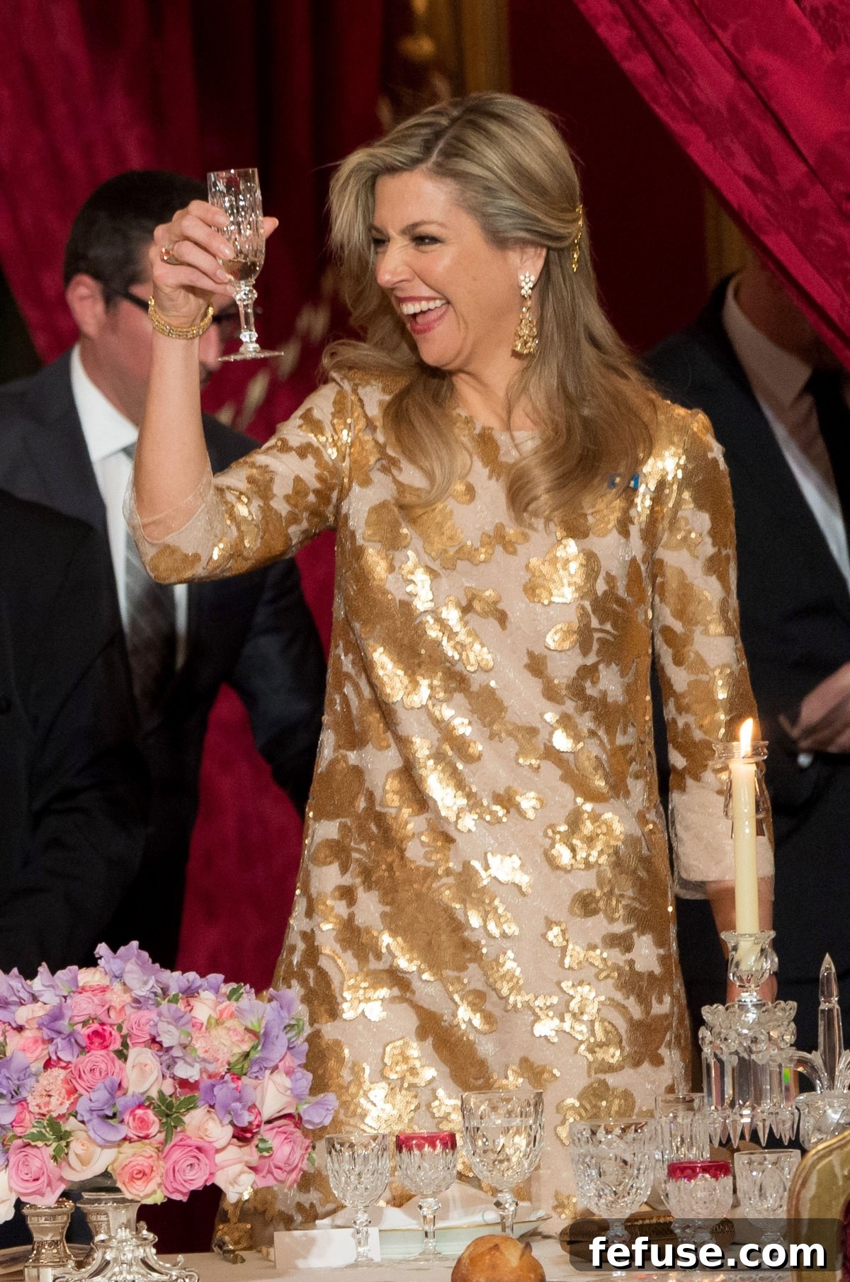 Queen Maxima of the Netherlands elegantly toasts during the French state dinner in Paris on March 10, 2016, showcasing her exquisite royal jewelry and regal presence.
