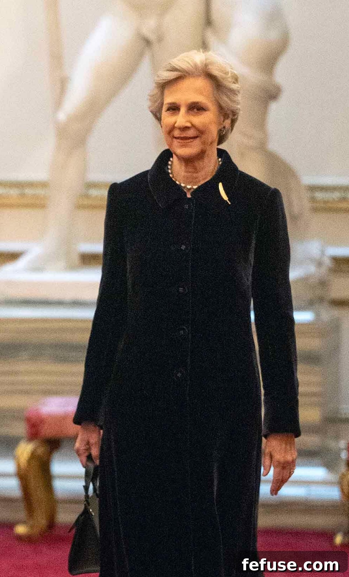 The Duchess of Gloucester wearing a pearl necklace and gold feather brooch at the WOW reception