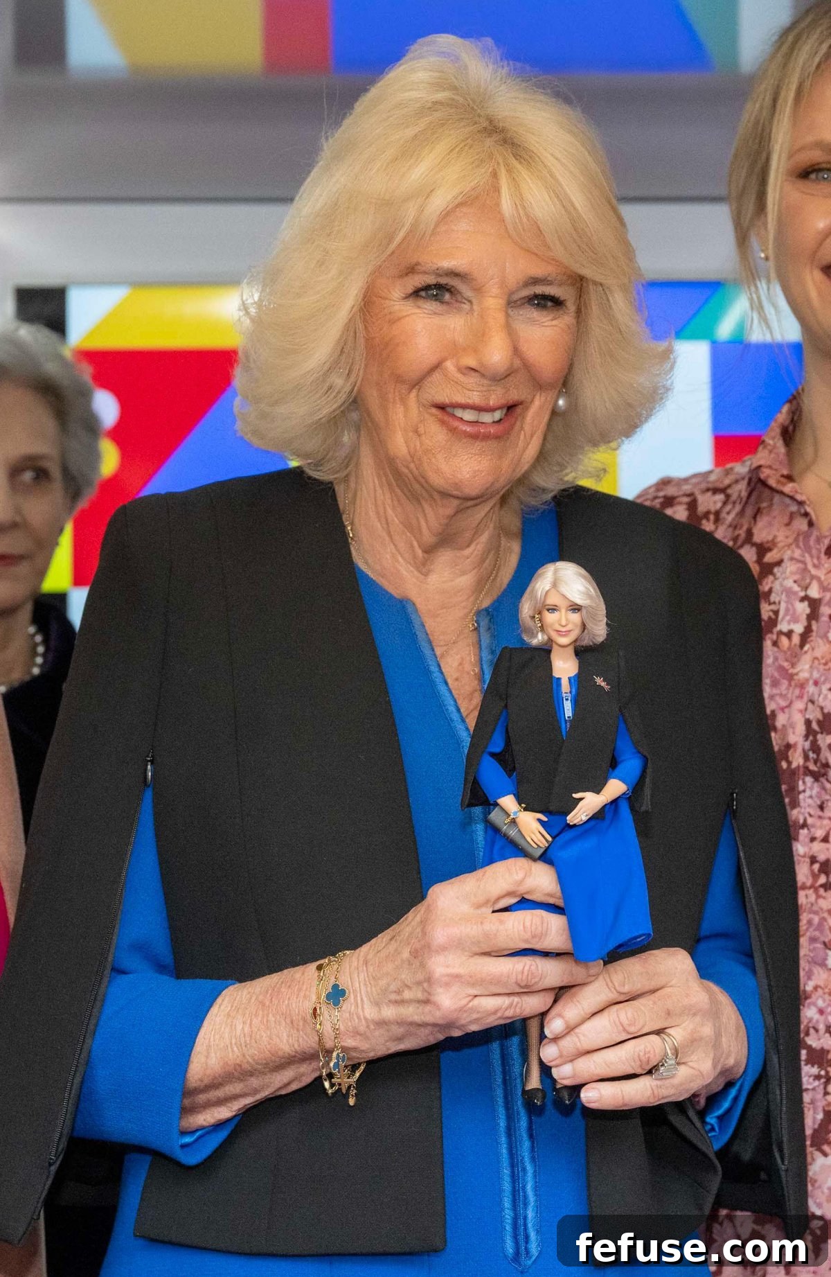 Queen Camilla reacts to receiving a Barbie doll created in her likeness at the WOW reception