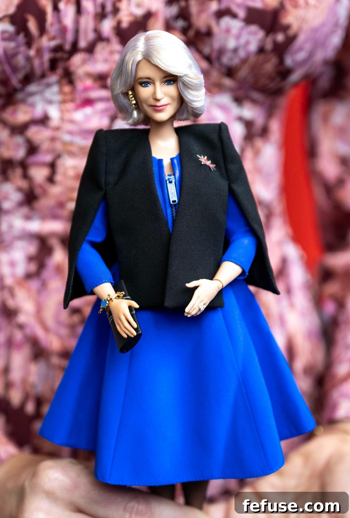 Close-up of the Queen Camilla Barbie doll, replicating her outfit and jewelry