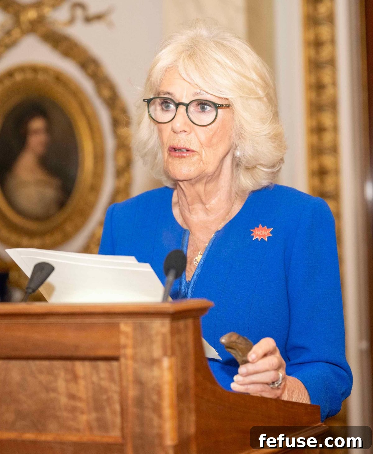 Queen Camilla delivers a speech during the Women of the World (WOW) reception, holding historical suffragette stones