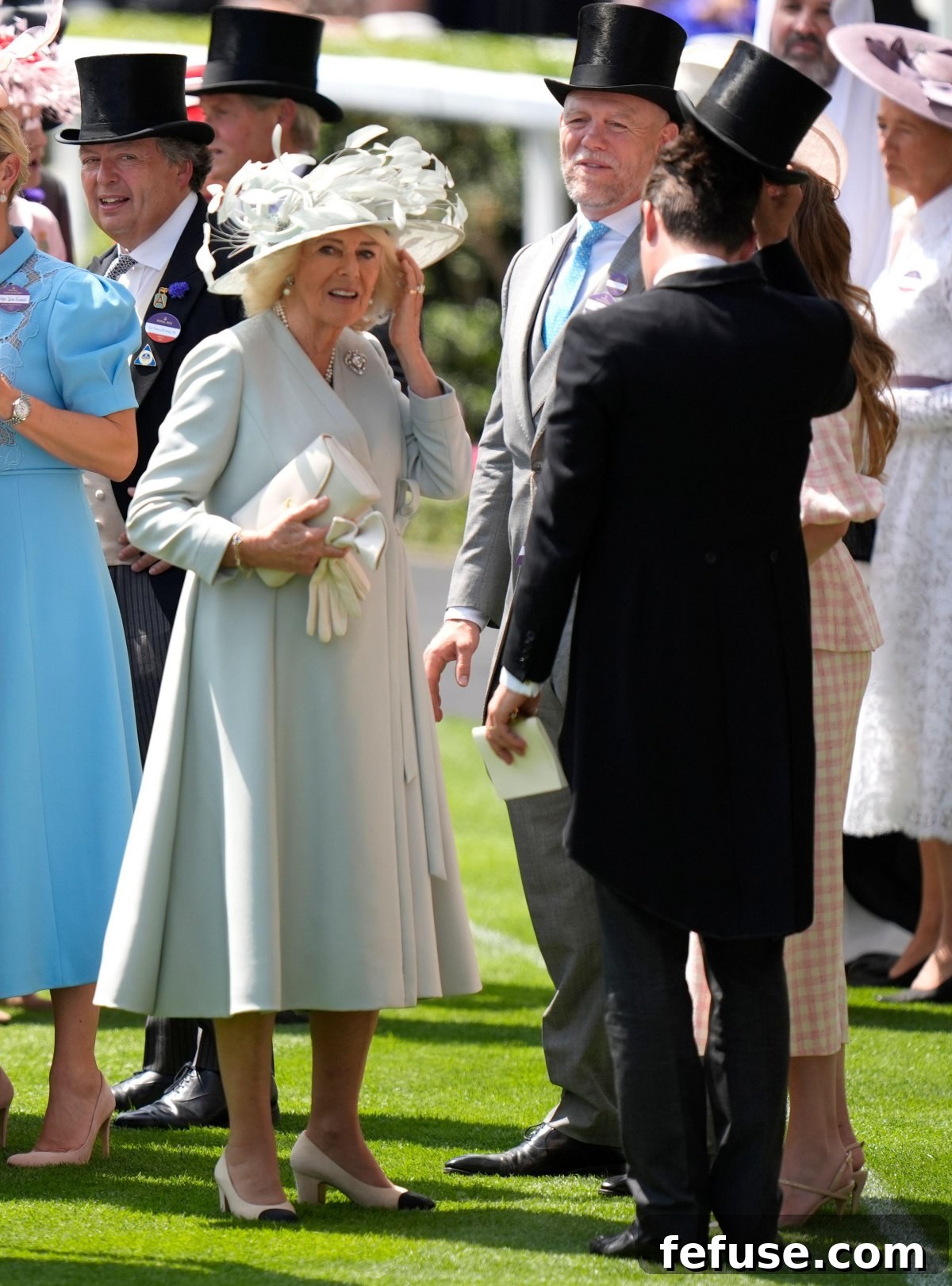 Queen Camilla elegantly dressed in mint green, featuring a Dior coat and Philip Treacy hat, attending Royal Ascot