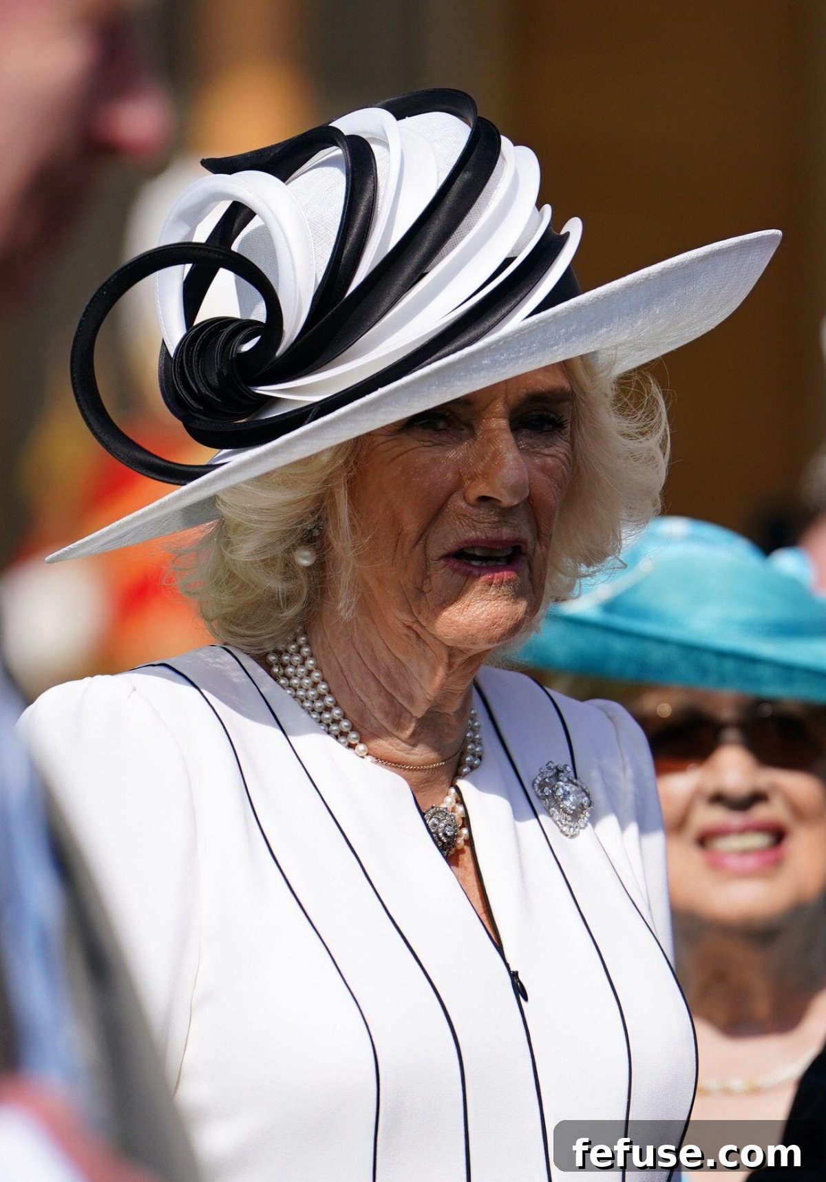 Queen Camilla wearing the Cullinan V Brooch as a traditional brooch at a Buckingham Palace garden party in May 2024